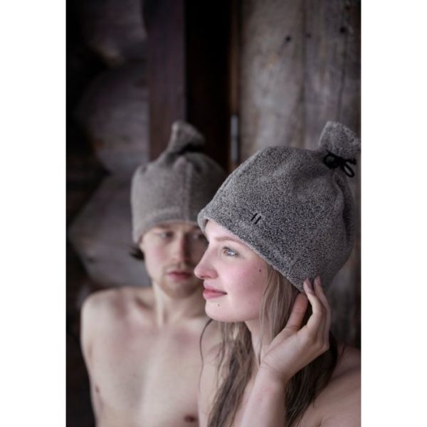 Picture of a woman and a man wearing sauna hats